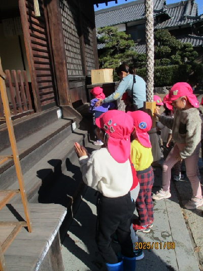 神社でお参りをする園児