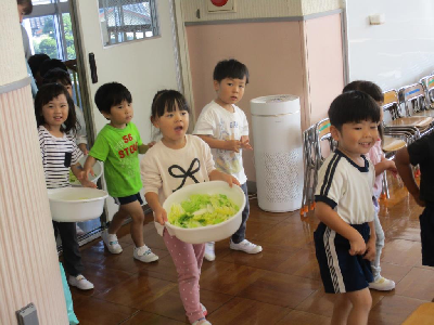 洗ったサツマイモをもっていく年少児