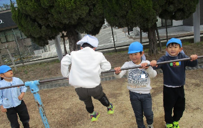 小学校の鉄棒をする年長児