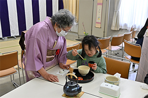茶碗に抹茶を入れる女の子