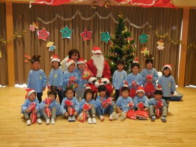 プレゼントをもらった園児たちとサンタクロースとの集合写真