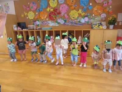 かえるのお面をつけて遊ぶ2歳児