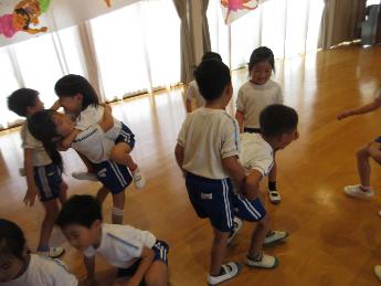 友達と抱っこしてすいかとどちらが重いが比べる5歳児