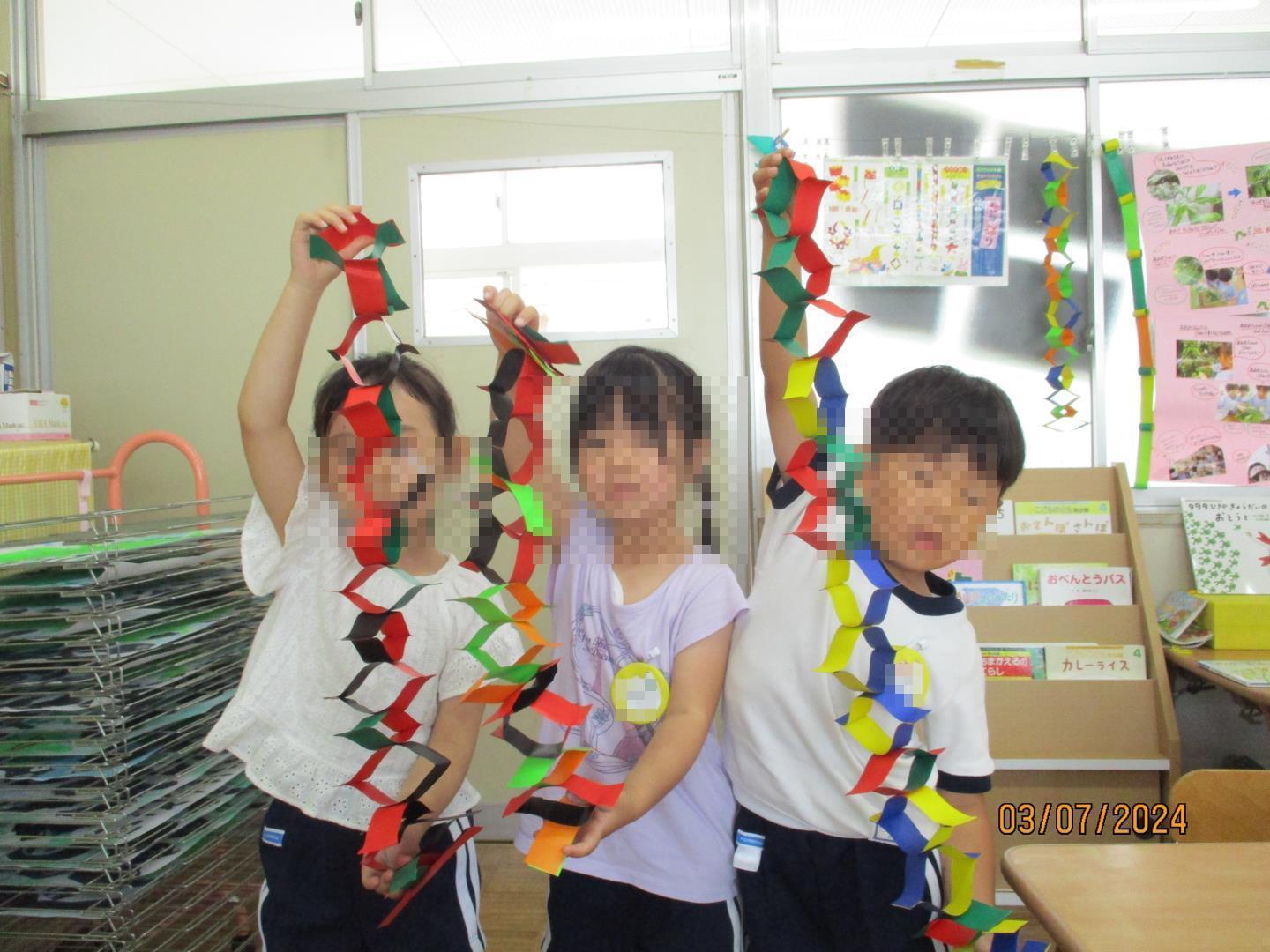 七夕飾りを持っている幼児