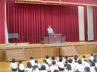 全校生徒の前で、学校長が話をしている様子。