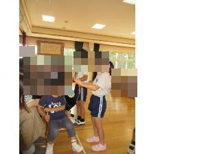 5歳児がふれあいさんにメダルをかけているところ
