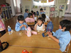 幼児がサツマイモのバター焼きを食べているところ