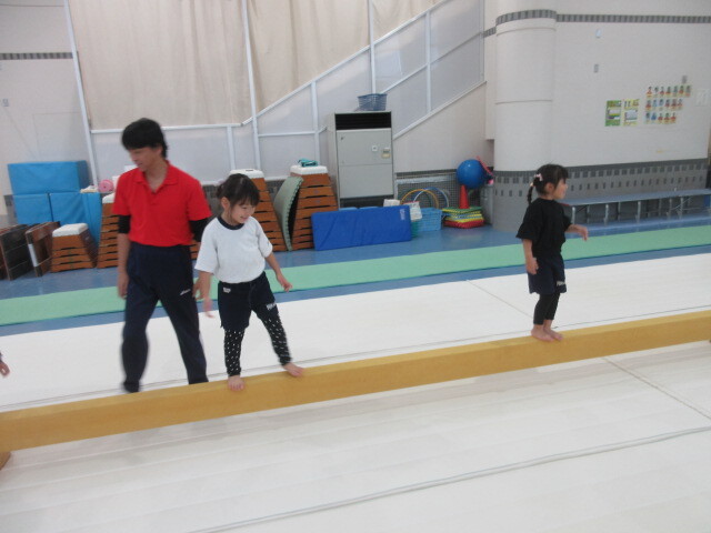 幼児が平均台を渡っている様子