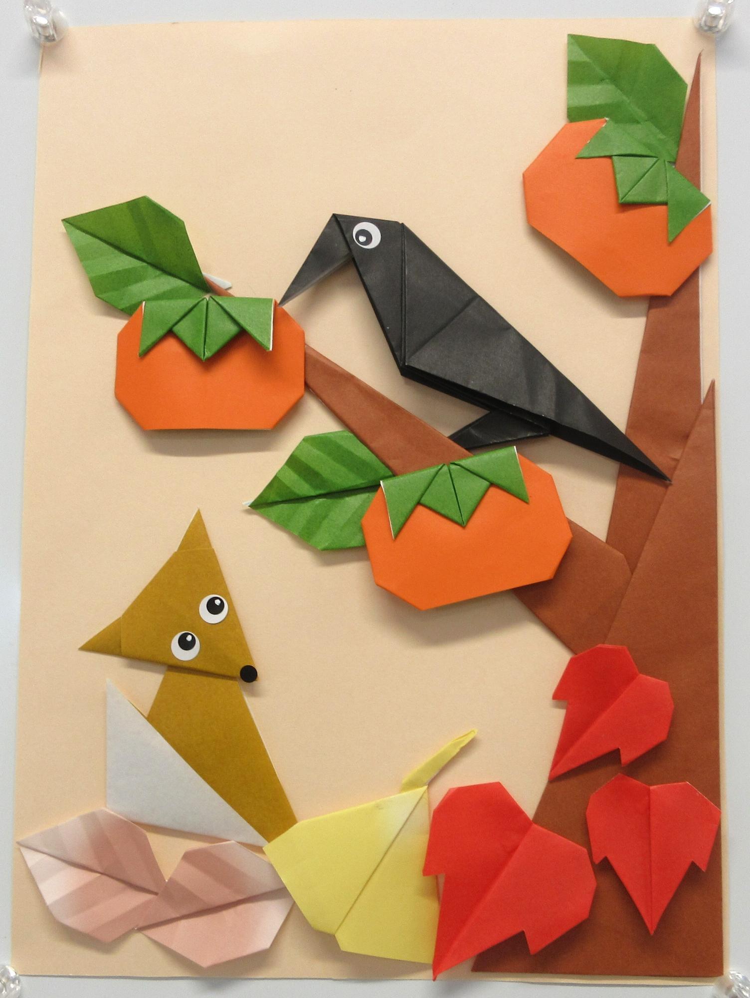 カラスが止まる柿の木を見上げるきつね