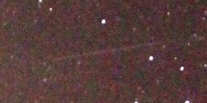 夜空見えるたくさんの星の光の点とともに人工衛星が通った跡が線になって見える写真