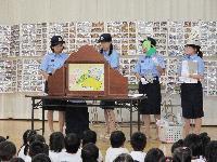 子どもたちに紙芝居を用いて防火の話をする女性署員たちの写真